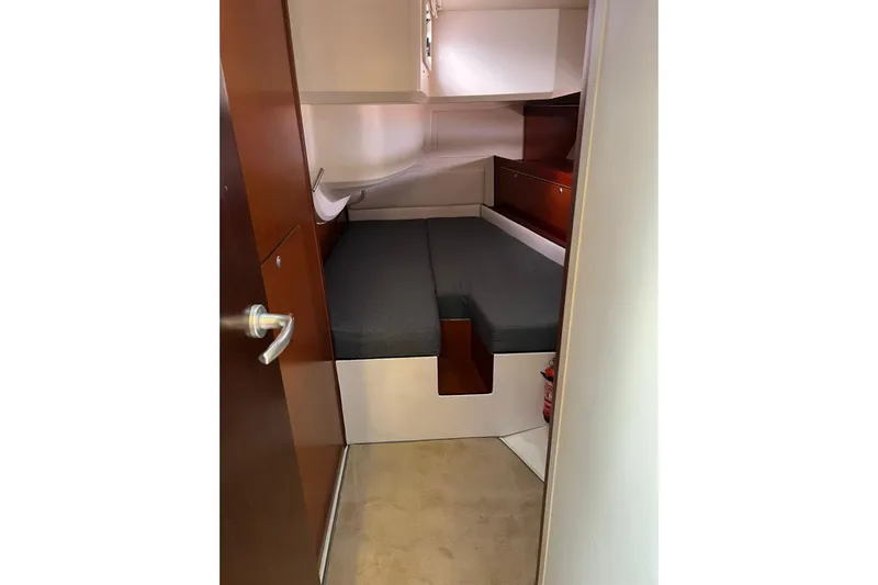  Yacht Photos Pics Cabin interior of 2013 Hanse 575 yacht with bed and wooden accents.