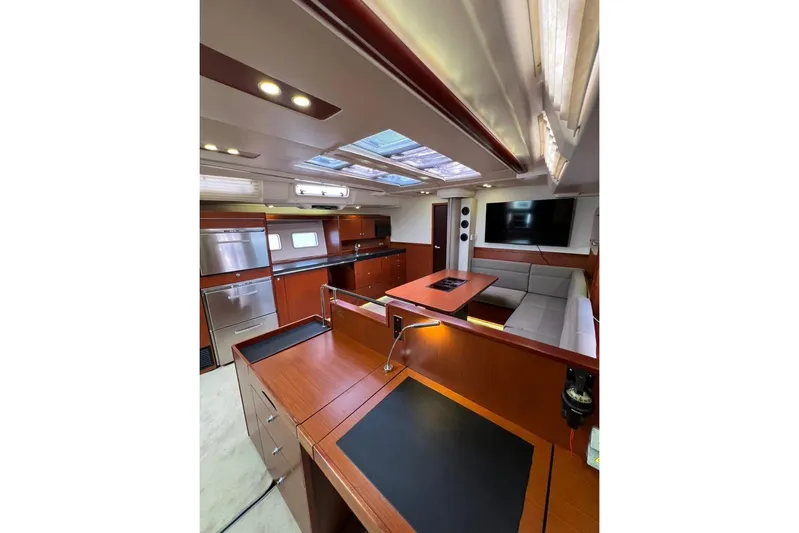  Yacht Photos Pics Luxurious interior of 2013 Hanse 575 yacht with modern kitchen and seating area.