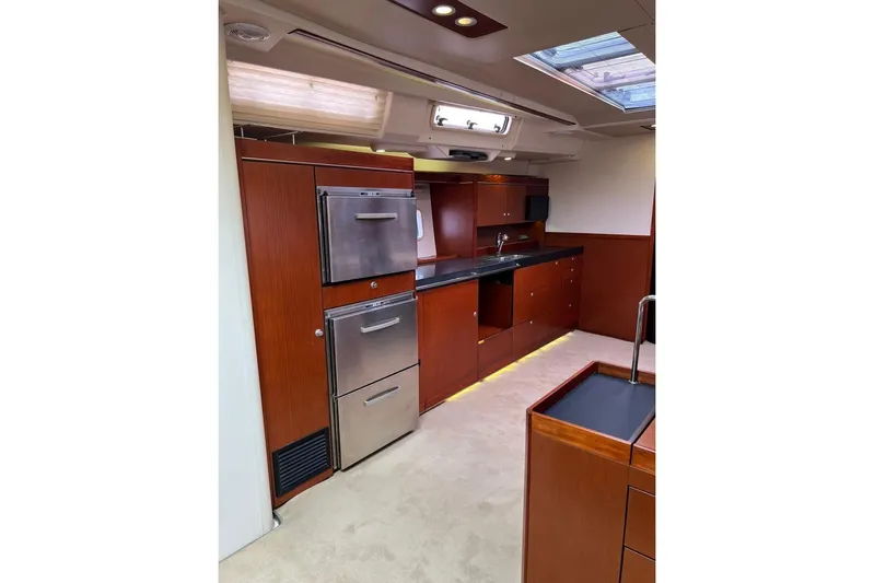  Yacht Photos Pics Luxurious 2013 Hanse 575 yacht interior kitchen with modern appliances and wood cabinetry.