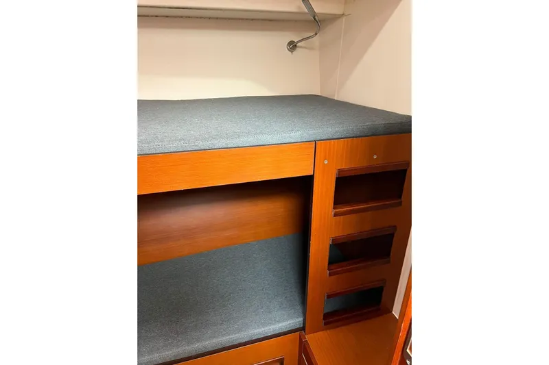  Yacht Photos Pics Interior of 2013 Hanse 575 yacht with wooden cabinetry and cushioned seating.