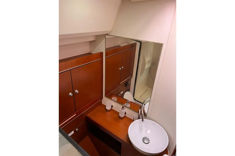  Yacht Photos Pics Luxurious bathroom interior of 2013 Hanse 575 yacht with wooden cabinetry and modern sink.