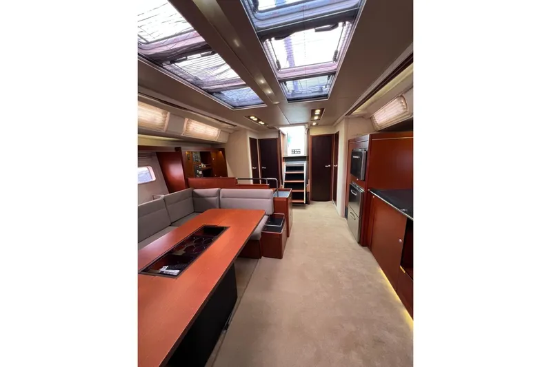  Yacht Photos Pics Luxurious interior of 2013 Hanse 575 yacht with modern kitchen and seating area.