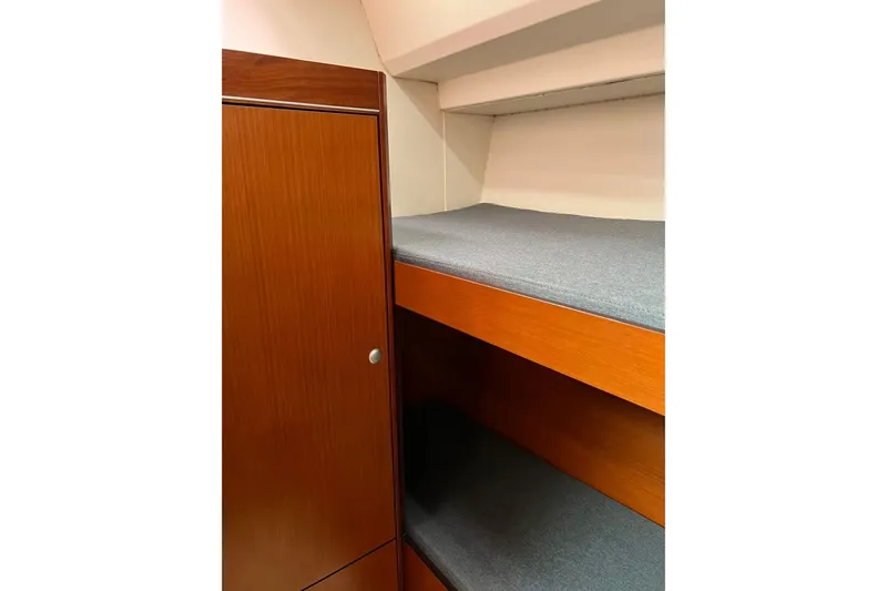  Yacht Photos Pics Interior of 2013 Hanse 575 yacht with wooden cabinetry and bunk beds.