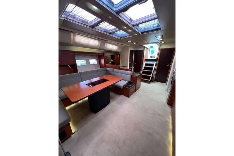  Yacht Photos Pics Luxurious interior of 2013 Hanse 575 yacht with skylights and elegant seating area.