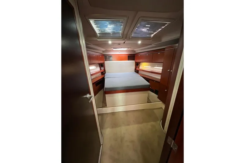  Yacht Photos Pics Luxurious cabin interior of 2013 Hanse 575 yacht with cozy bed and wooden finish.