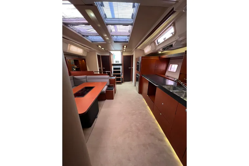 Yacht Photos Pics Luxurious interior of 2013 Hanse 575 yacht with modern kitchen and seating area.