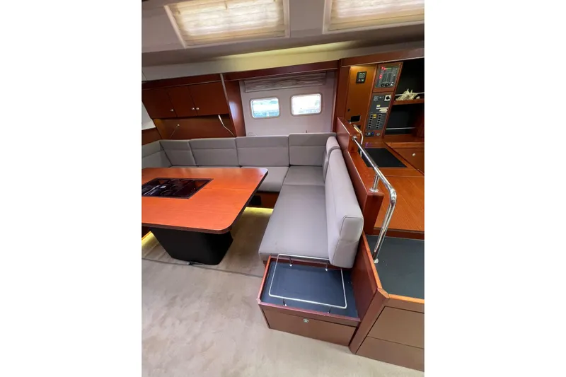  Yacht Photos Pics Interior of 2013 Hanse 575 yacht with modern seating and wooden table.