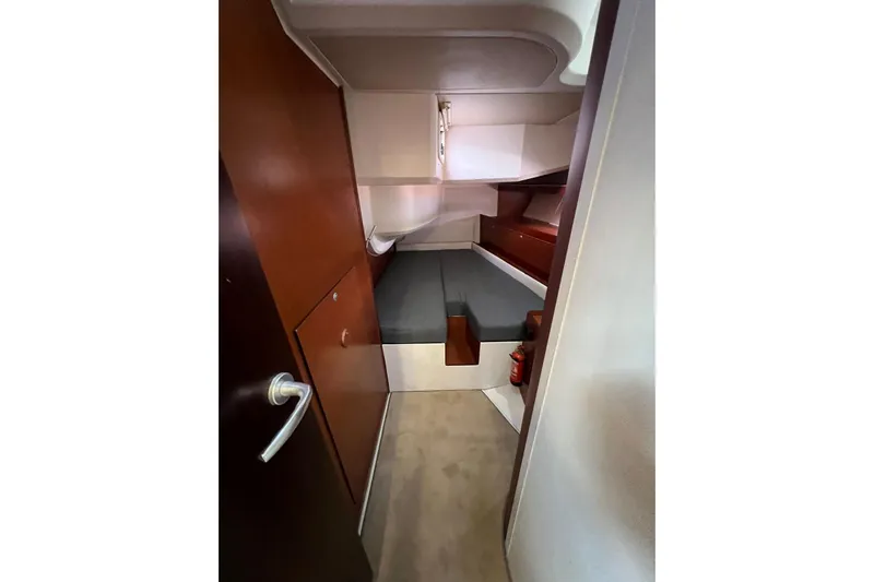  Yacht Photos Pics Interior cabin of 2013 Hanse 575 yacht with wooden finish and compact bed.