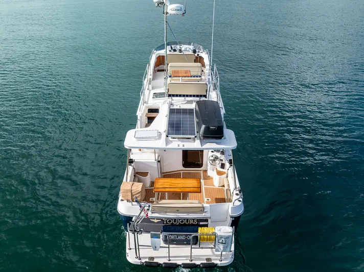 Toujours Yacht Photos Pics 2021 Ranger Tugs R-31 CB boat on calm water, aerial view.