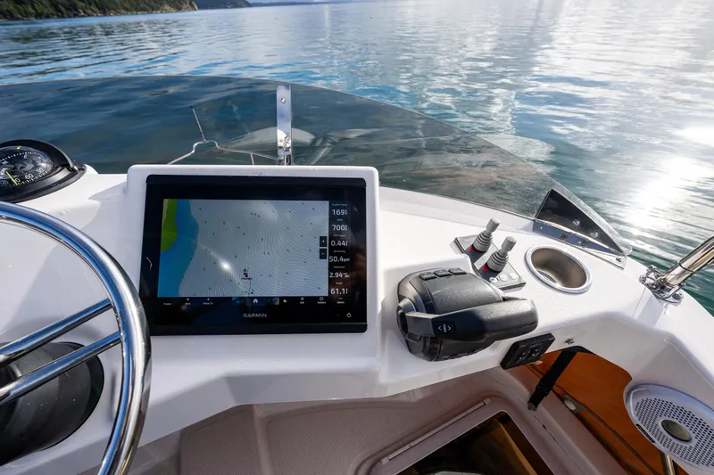 Toujours Yacht Photos Pics 2021 Ranger Tugs R-31 CB helm with navigation display on calm water.