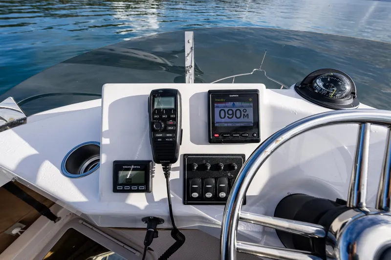 Toujours Yacht Photos Pics 2021 Ranger Tugs R-31 CB helm with navigation instruments and steering wheel.