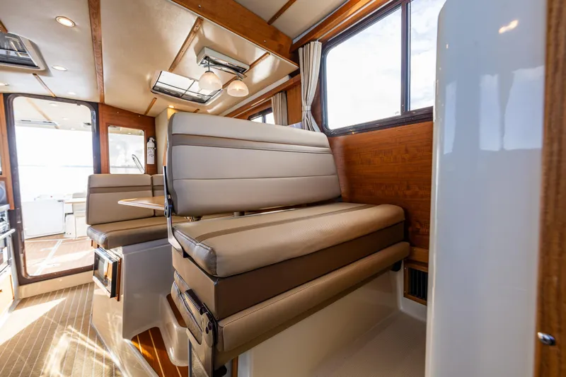 Toujours Yacht Photos Pics Interior of 2021 Ranger Tugs R-31 CB, featuring modern seating and wood accents.