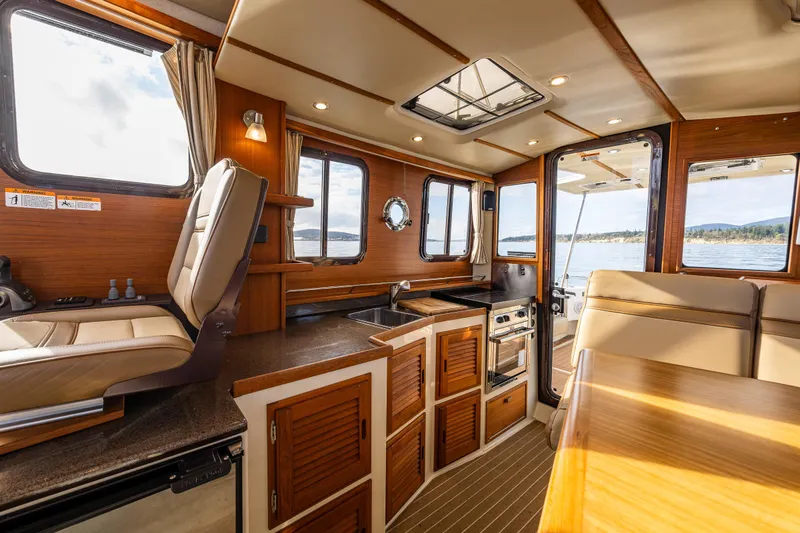 Toujours Yacht Photos Pics Interior of 2021 Ranger Tugs R-31 CB, featuring a modern kitchen and seating area.