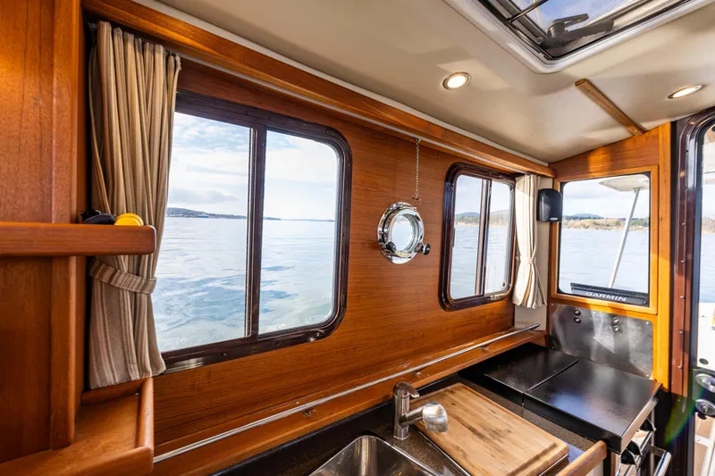 Toujours Yacht Photos Pics Interior of 2021 Ranger Tugs R-31 CB with wood finish and scenic window view.