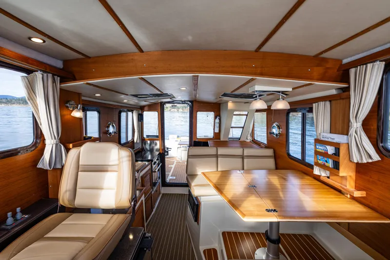 Toujours Yacht Photos Pics Interior of 2021 Ranger Tugs R-31 CB boat with wood finish and seating area.