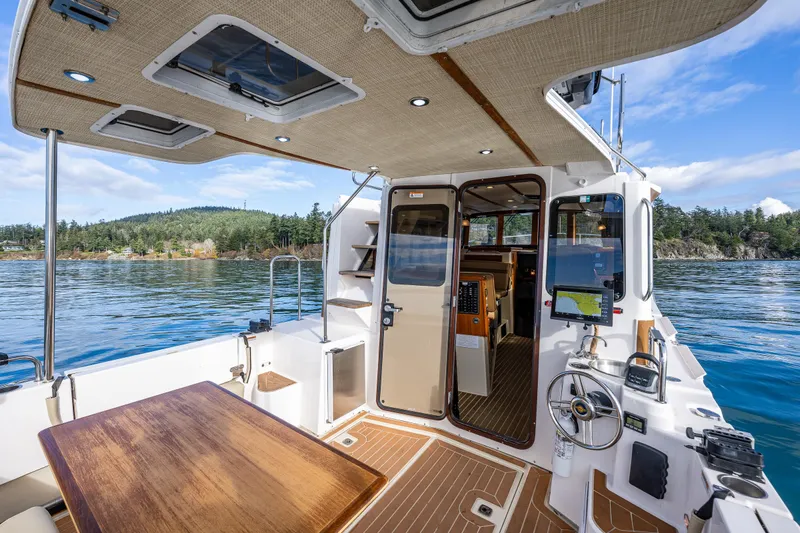 Toujours Yacht Photos Pics 2021 Ranger Tugs R-31 CB boat interior with scenic water view.