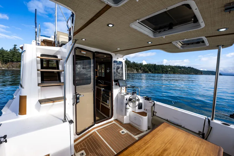 Toujours Yacht Photos Pics 2021 Ranger Tugs R-31 CB boat interior with scenic water view.