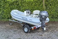 2022 AB Inflatables 9.5 Alx boat with Yamaha motor on trailer, parked outdoors.