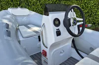 2022 AB Inflatables 9.5 Alx boat interior with steering wheel and seating.