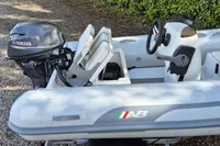 2022 AB Inflatables 9.5 Alx boat with Yamaha outboard motor, parked on gravel.