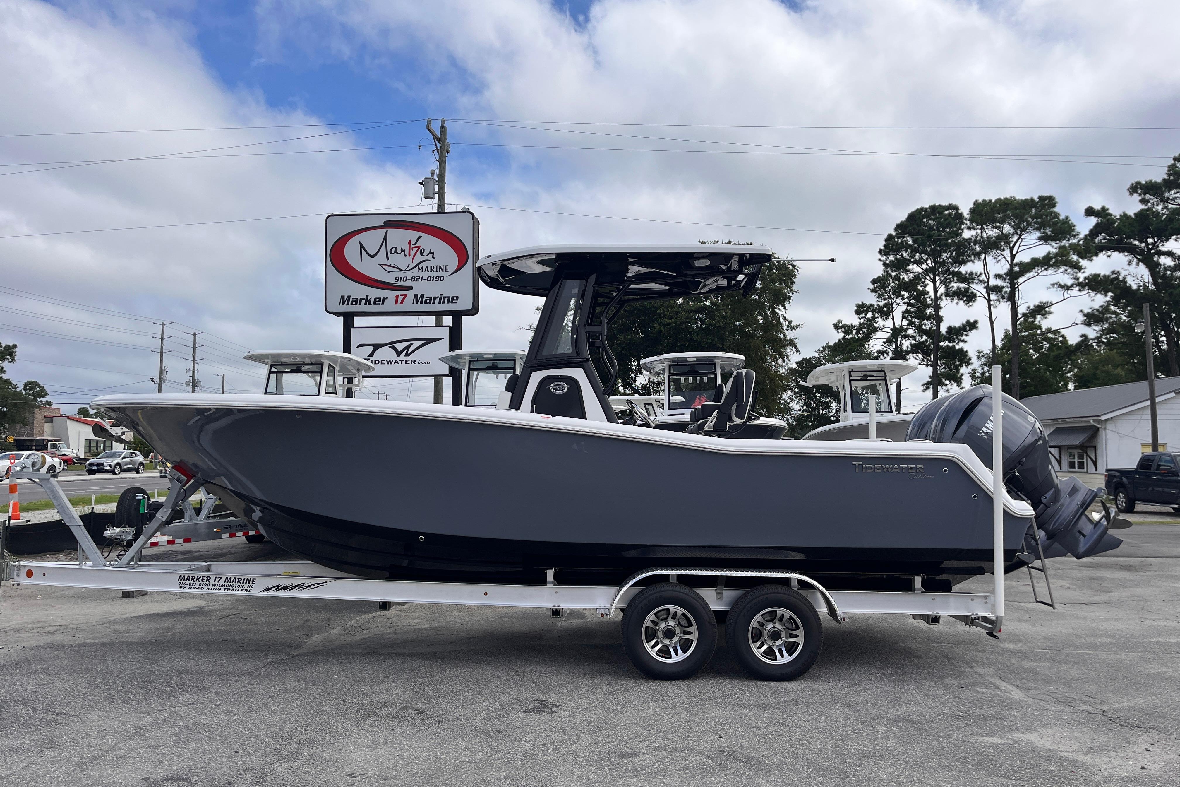 2026 Tidewater 256 CC Adventure boat on trailer at Marker 17 Marine dealership.