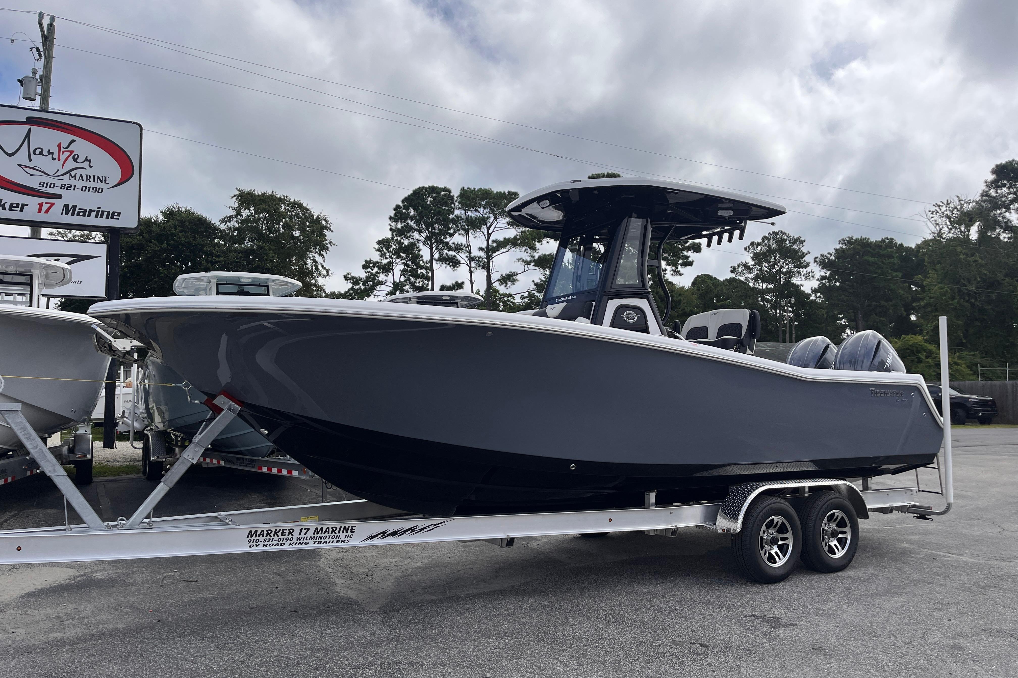 2026 Tidewater 256 CC Adventure boat on trailer at Marker 17 Marine dealership.