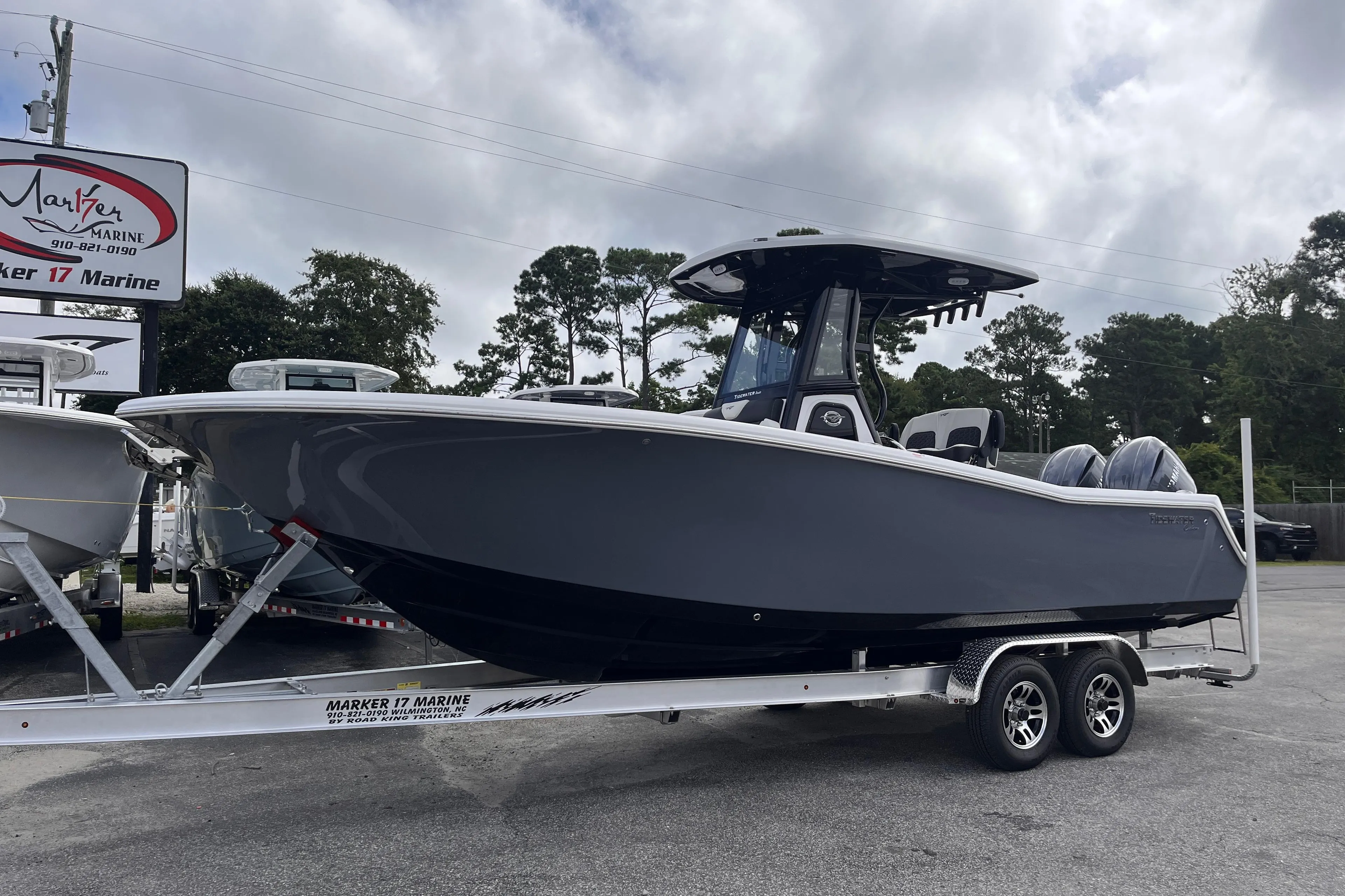 2026 Tidewater 256 CC Adventure boat on trailer at Marker 17 Marine dealership.