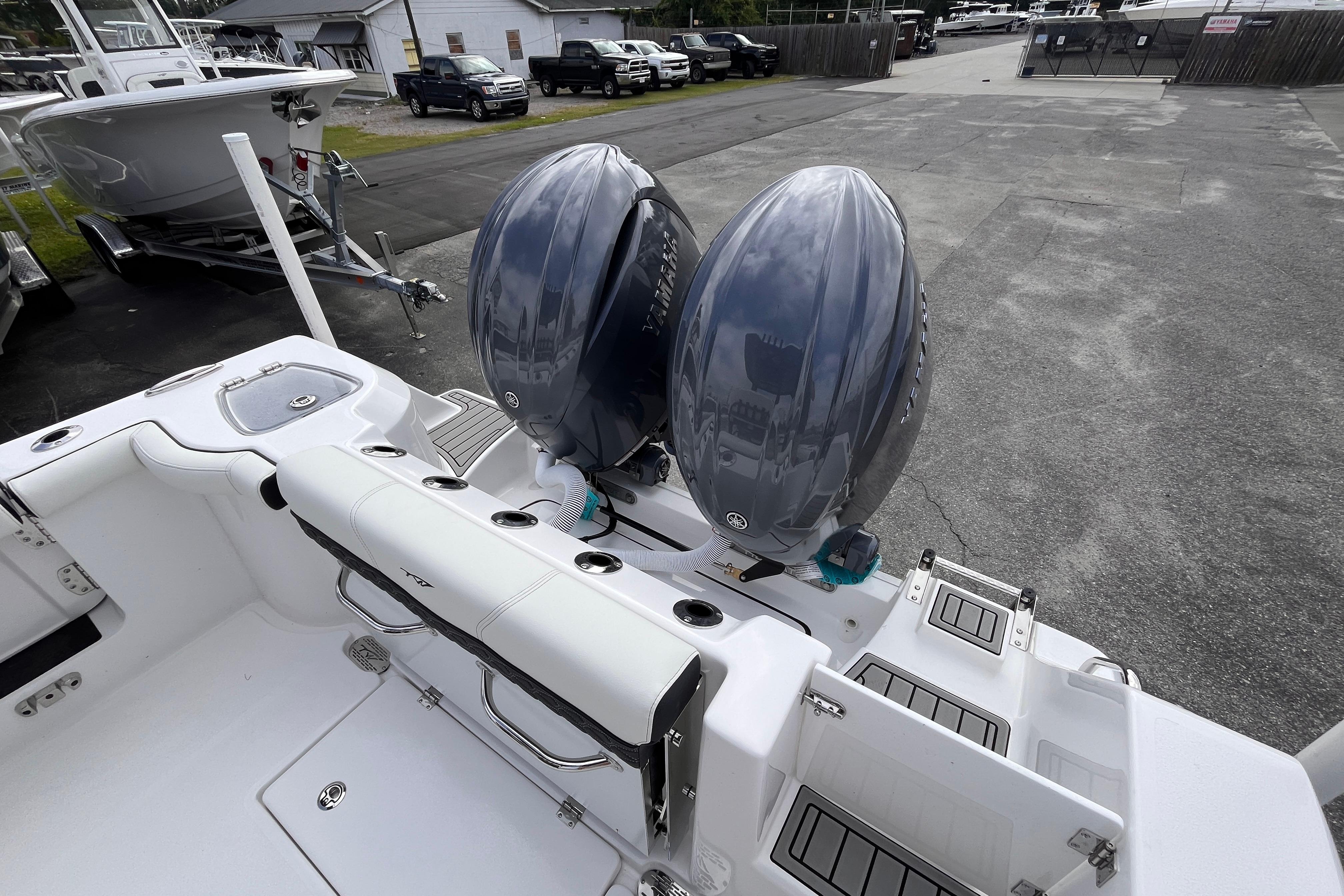 2026 Tidewater 256 CC Adventure boat with dual outboard engines in a marina setting.