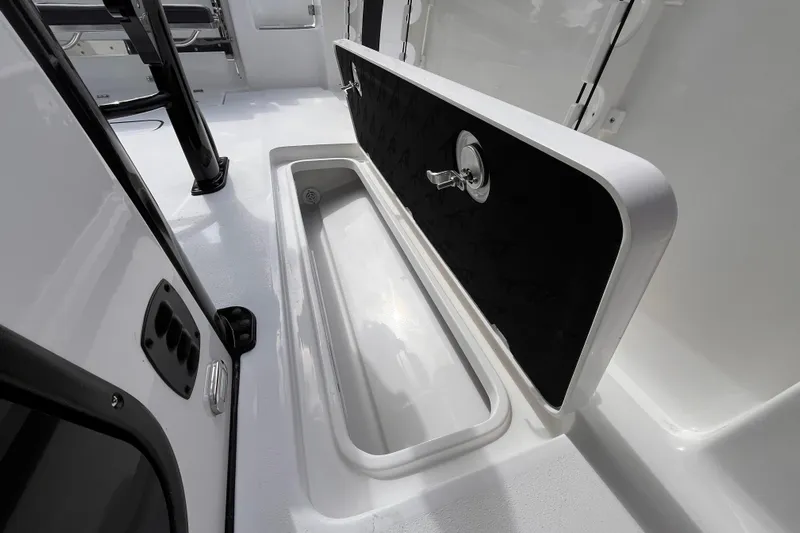  Yacht Photos Pics 2026 Tidewater 256 CC Adventure boat interior with open storage compartment.