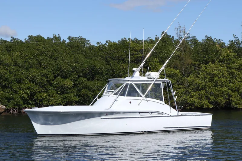 Lures & Liars Yacht Photos Pics 2002 Miller Marine 36 Express boat on calm water with lush green background.