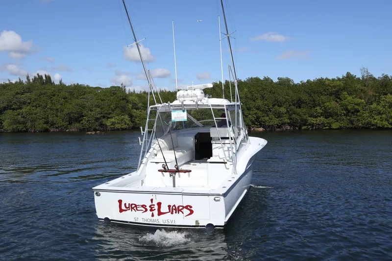Lures & Liars Yacht Photos Pics 2002 Miller Marine 36 Express boat on water, labeled "Lures & Liars," St. Thomas, USVI.