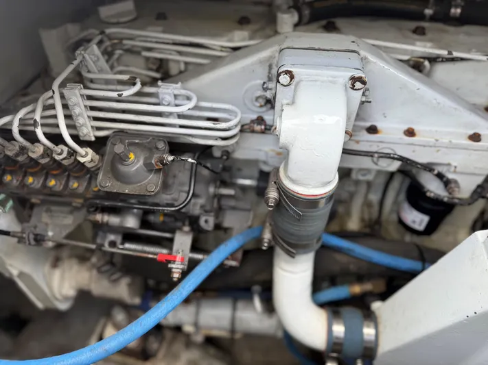 Lures & Liars Yacht Photos Pics Engine components of a 2002 Miller Marine Express boat, featuring pipes and mechanical parts.