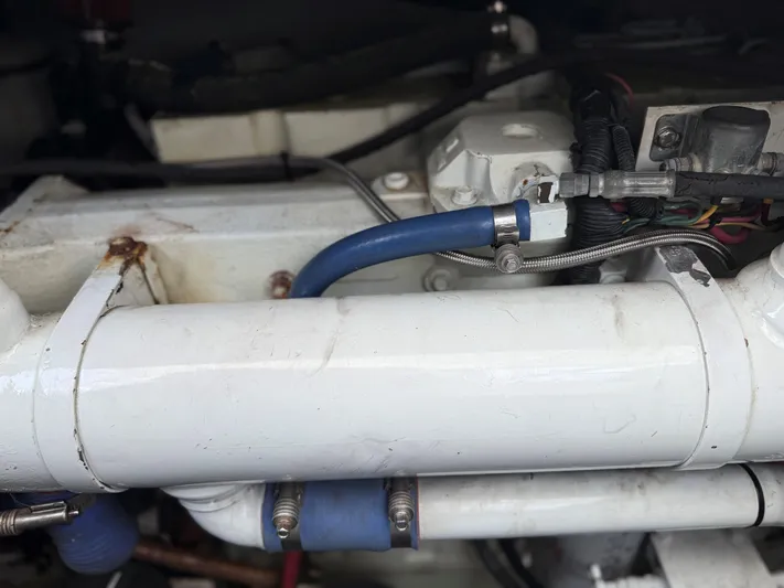 Lures & Liars Yacht Photos Pics Engine components of a 2002 Miller Marine Express boat, featuring pipes and wiring.