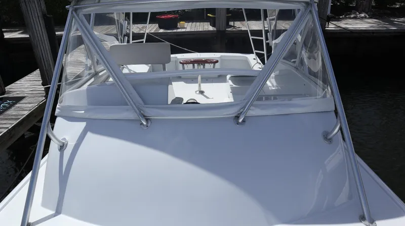 Lures & Liars Yacht Photos Pics 2002 Miller Marine Express boat docked, showcasing sleek design and spacious deck.