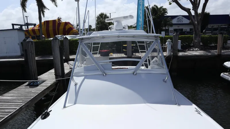 Lures & Liars Yacht Photos Pics 2002 Miller Marine Express boat docked at a marina with clear skies.