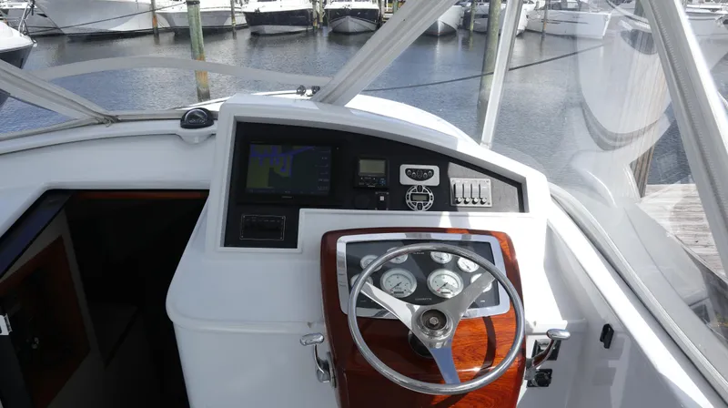 Lures & Liars Yacht Photos Pics 2002 Miller Marine Express boat helm with steering wheel and navigation controls.