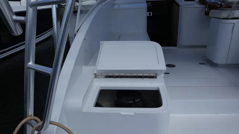 Lures & Liars Yacht Photos Pics 2002 Miller Marine Express boat deck with storage compartment and seating area.