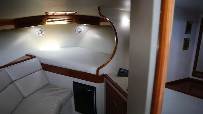 Lures & Liars Yacht Photos Pics Interior of 2002 Miller Marine Express boat with cozy seating and bed area.