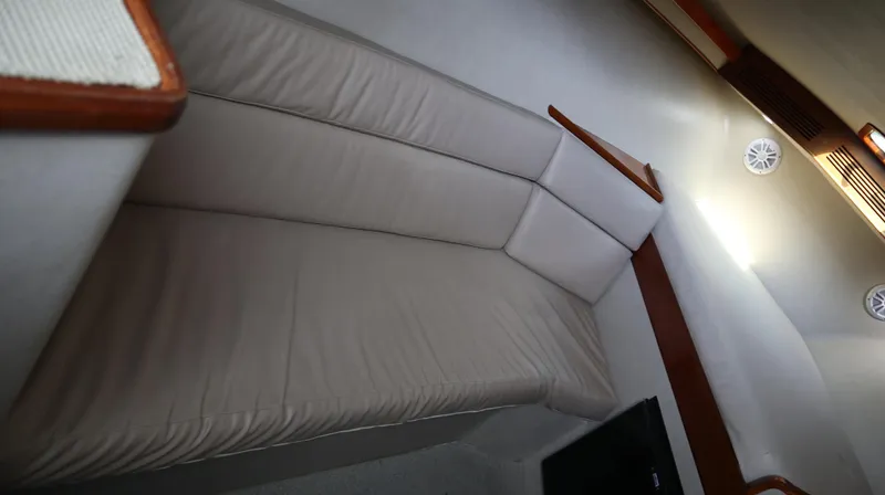 Lures & Liars Yacht Photos Pics 2002 Miller Marine Express interior with beige seating and wooden accents.