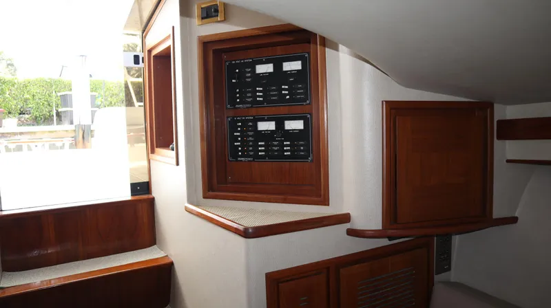 Lures & Liars Yacht Photos Pics Interior of 2002 Miller Marine Express boat with wooden paneling and control panels.