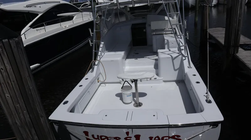 Lures & Liars Yacht Photos Pics 2002 Miller Marine Express boat docked, featuring spacious deck and seating area.