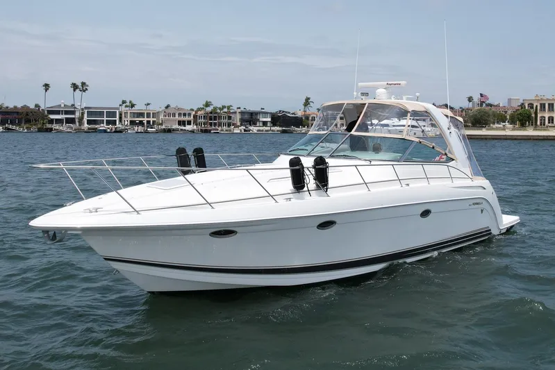 Aloha Spirit Yacht Photos Pics 2003 Formula 40 PC yacht cruising on a sunny day near waterfront homes.