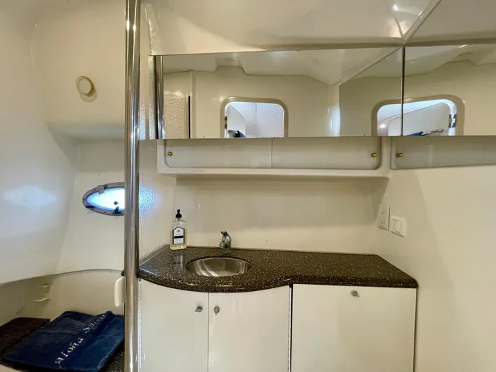 Aloha Spirit Yacht Photos Pics 2003 Formula 40 PC yacht bathroom with sink, mirror, and storage cabinets.