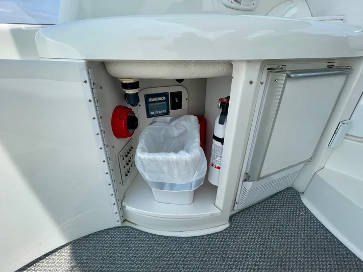 Aloha Spirit Yacht Photos Pics 2003 Formula 40 PC yacht interior with storage compartment, fire extinguisher, and trash bin.