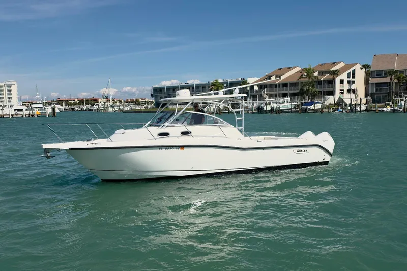  Yacht Photos Pics 2007 Boston Whaler 305 Conquest boat cruising near waterfront homes.