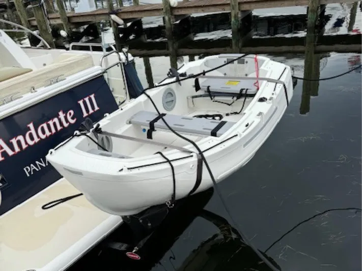 Andante III Yacht Photos Pics Small white boat docked beside Sabre 45 Salon Express, 2017 model.