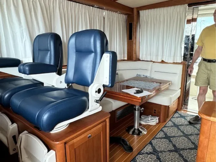Andante III Yacht Photos Pics Interior of 2017 Sabre 45 Salon Express with blue seats and wooden accents.