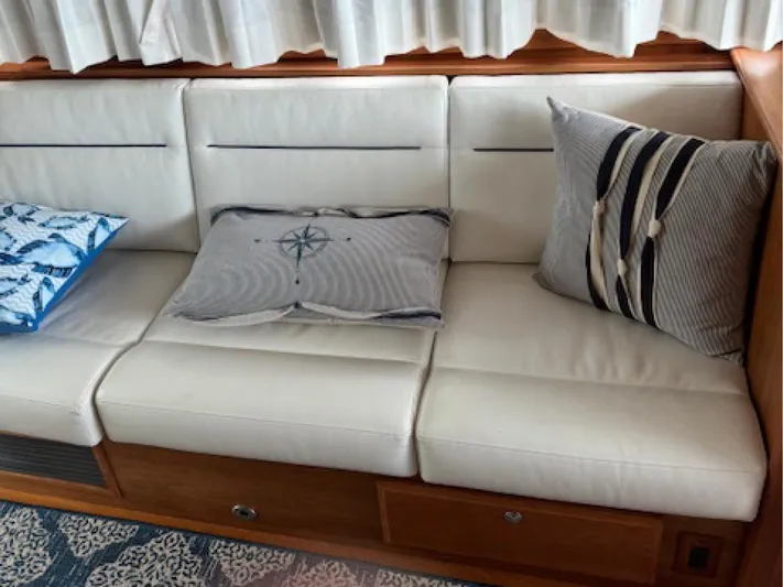 Andante III Yacht Photos Pics White leather seating with decorative pillows on a 2017 Sabre 45 Salon Express yacht.