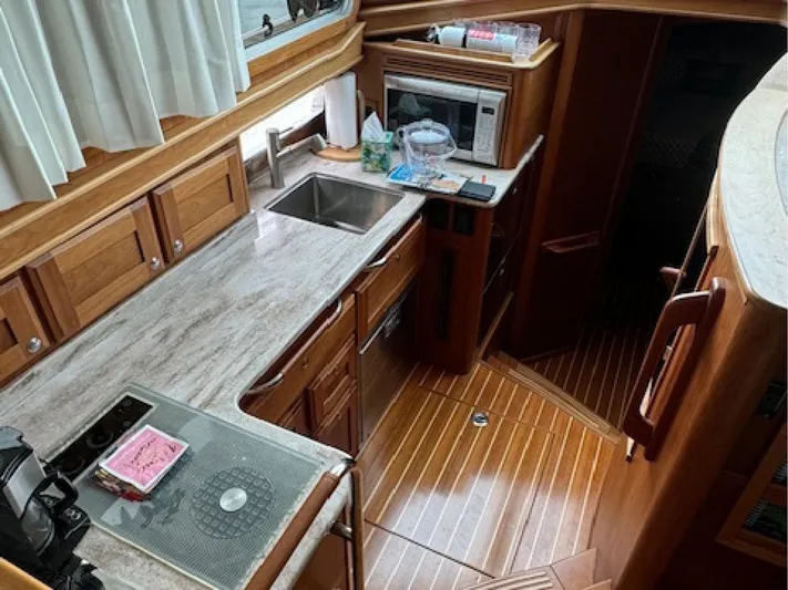 Andante III Yacht Photos Pics 2017 Sabre 45 Salon Express yacht kitchen with wood cabinetry and modern appliances.