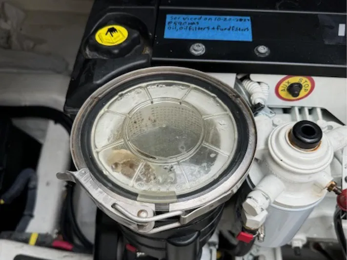 Andante III Yacht Photos Pics Engine compartment of 2017 Sabre 45 Salon Express with visible filter and maintenance note.